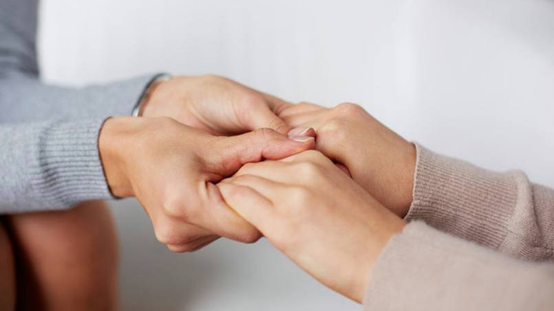 caring-hands-holding-each-other-for-comfort-16x9.jpg